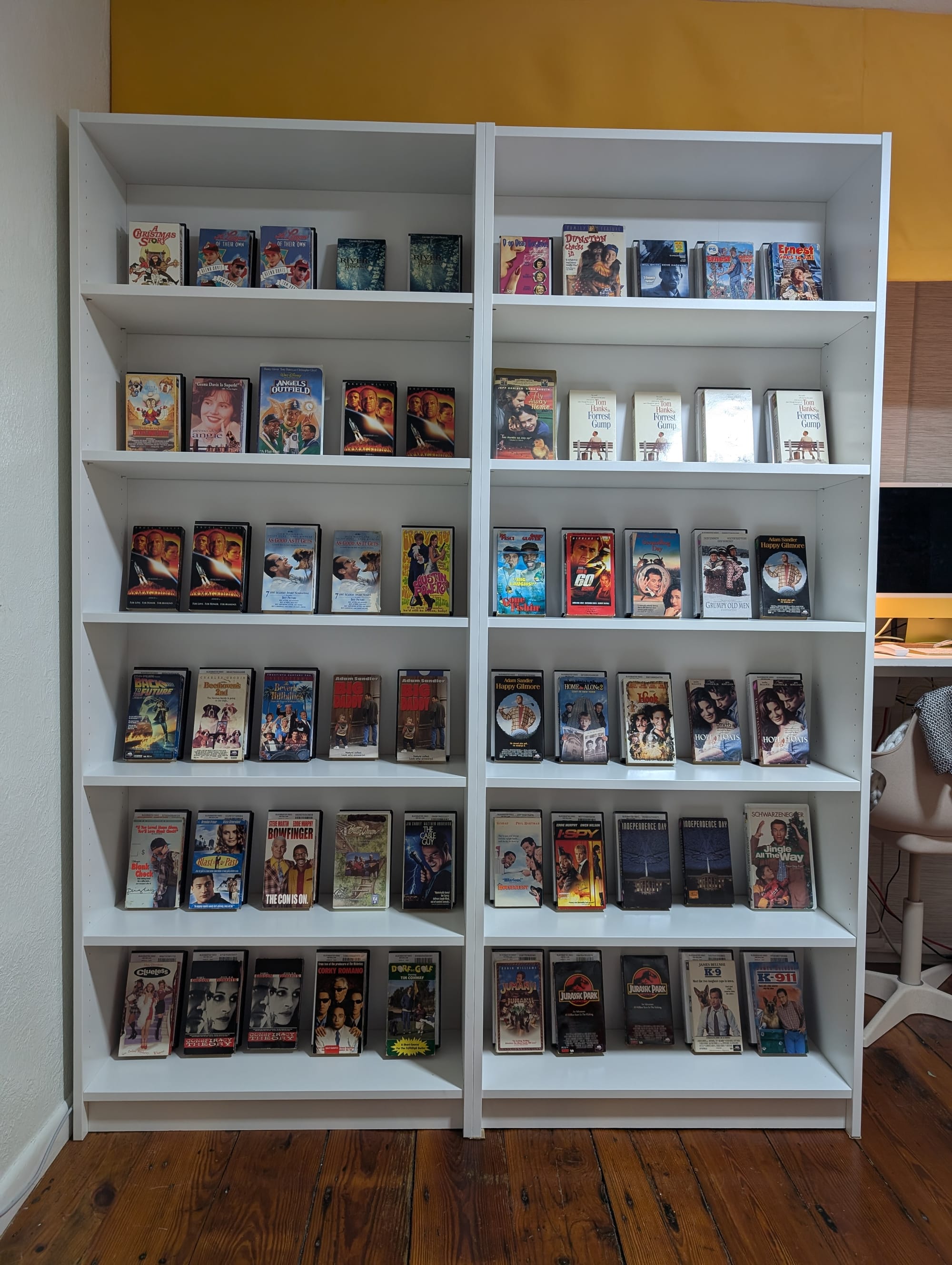 Two bookshelves assembled together with the office desk peeking through behind