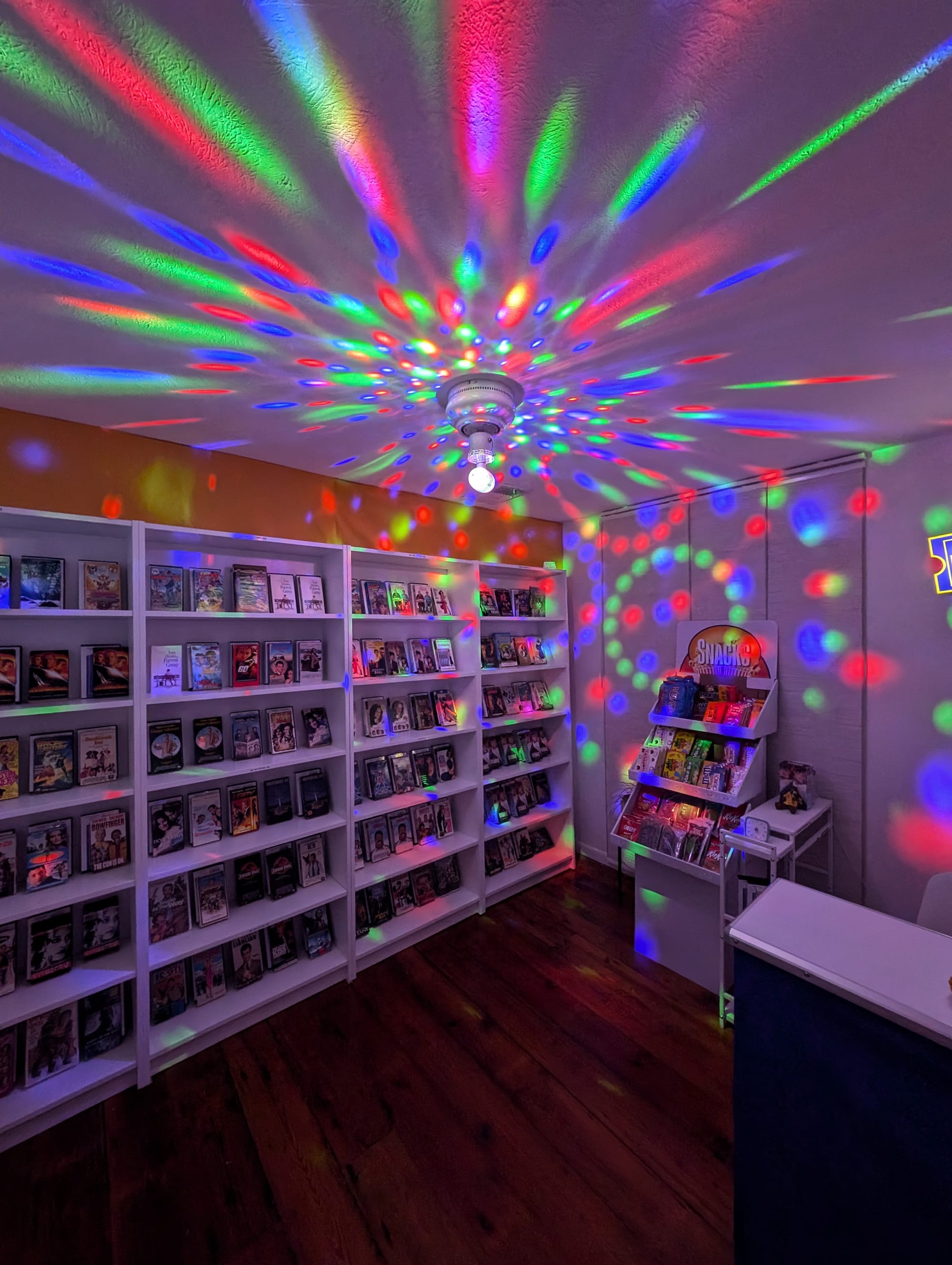 More party guests inside the store, lights turned down